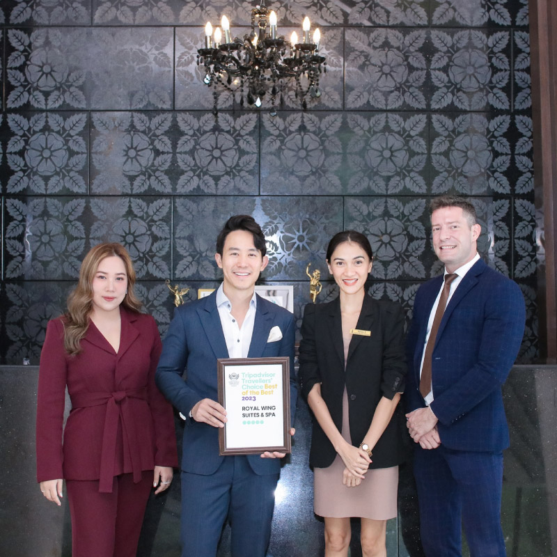Royal Wing Suites & Spa management taking photo with their 9th best of the best Tripadvisor award