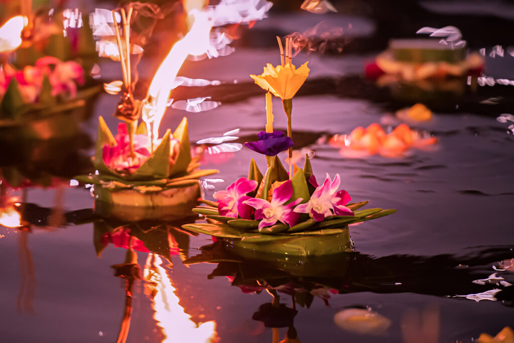 Loy Krathong floating on a river at night during a Pattaya event
