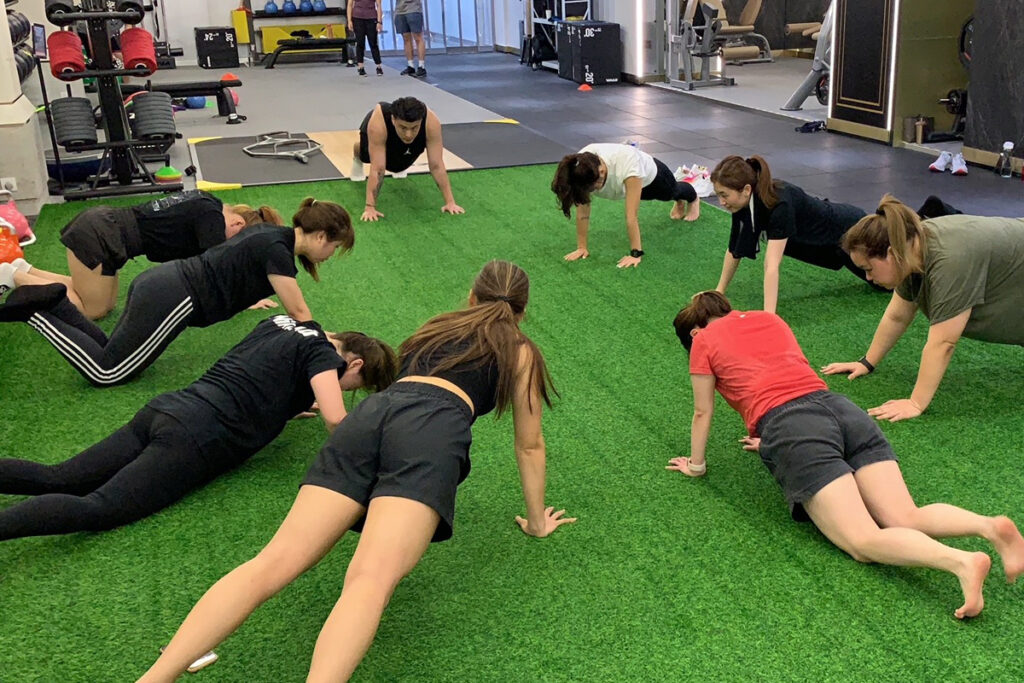 Coach Steven leading an indoor exercise bootcamp at FITZ Club