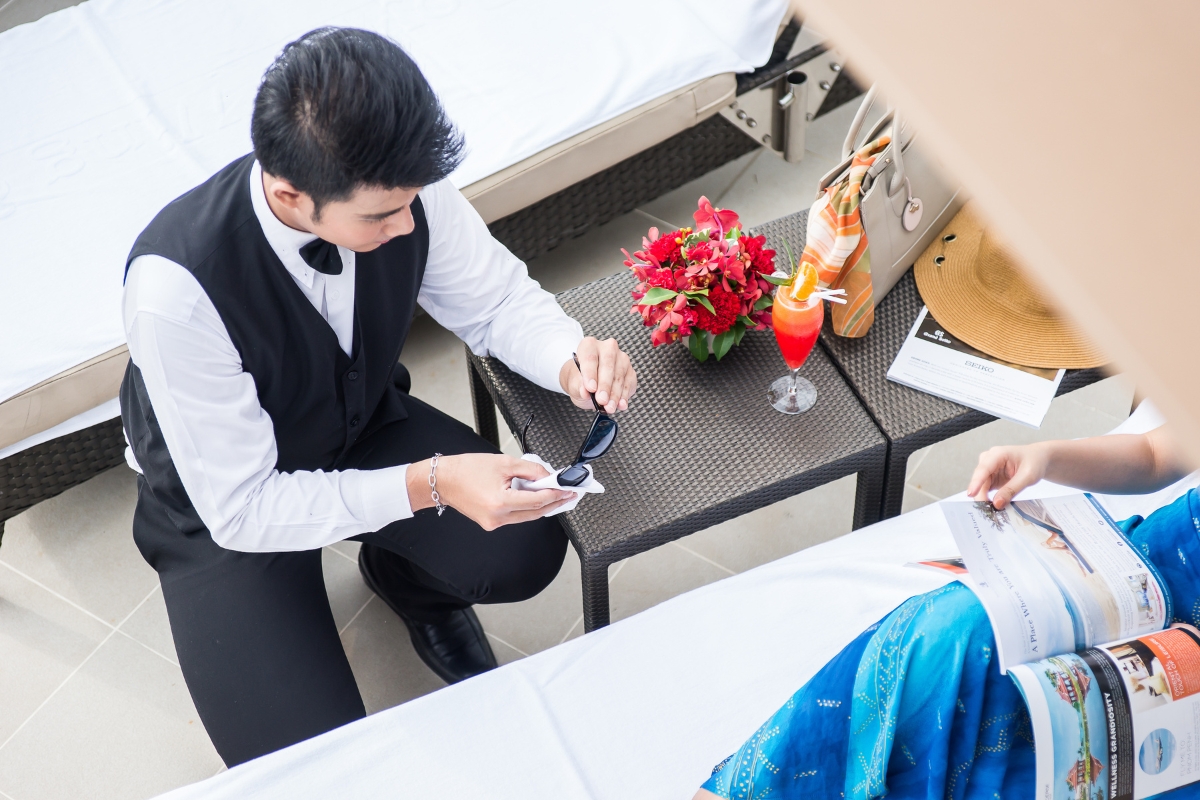 personal butler at our ultra luxury hotel providing sunglasses cleaning service