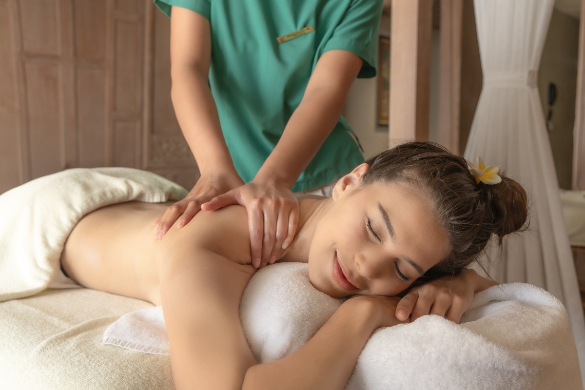 woman relaxing and enjoying the benefits of a thai massaage