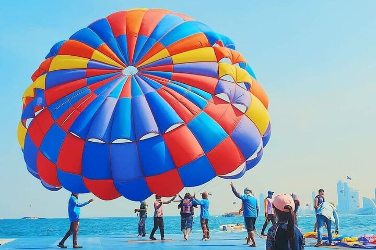 parasailing operators helping person out of a parasail