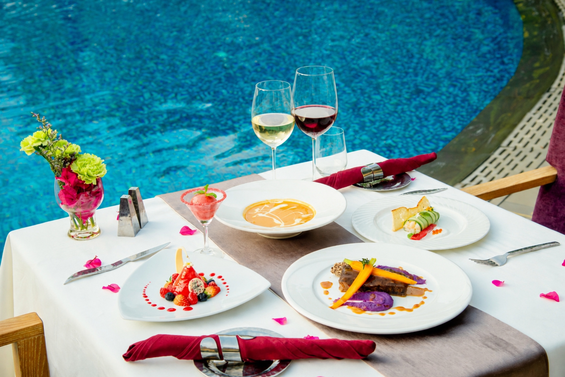 red wine and white wine pairings on a table with a fine dining meal
