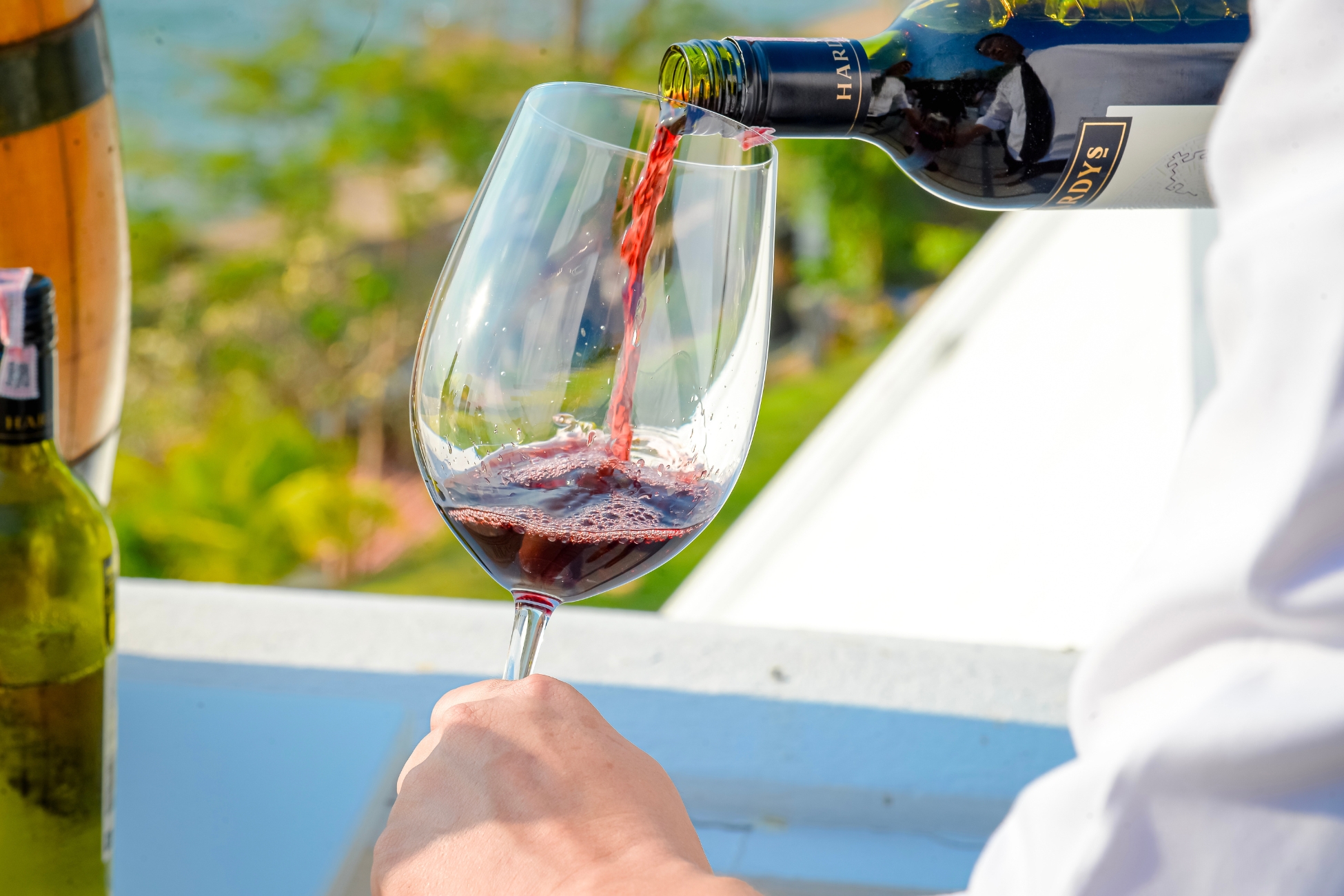 pouring red wine into a wine glass